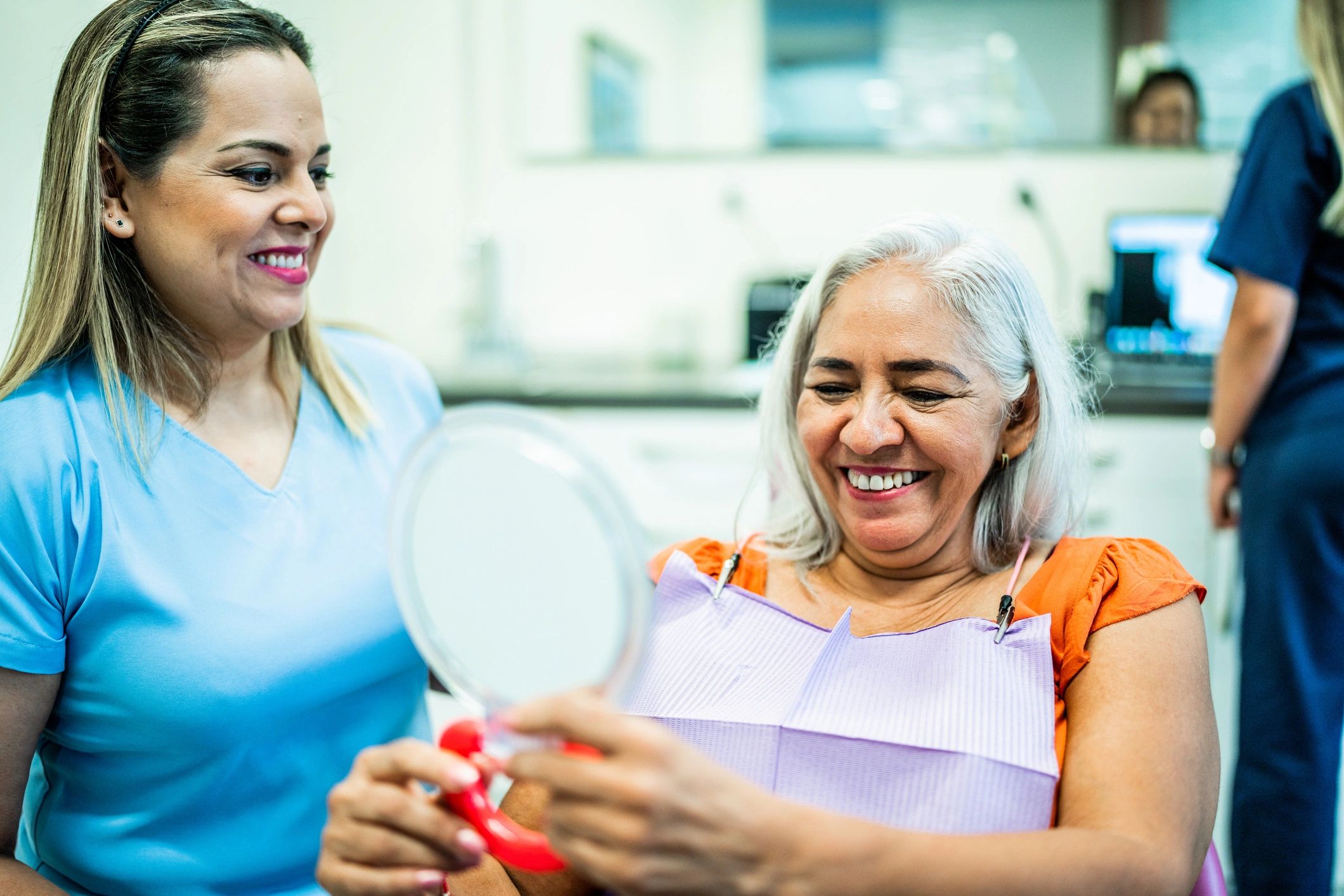 Patient reviewing her smile during a dental consultation